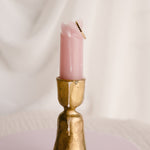Dot stacking ring available in 14k gold filled and sterling silver, styled on melted pink candle in vintage gold candlestick holder with neutral backdrop